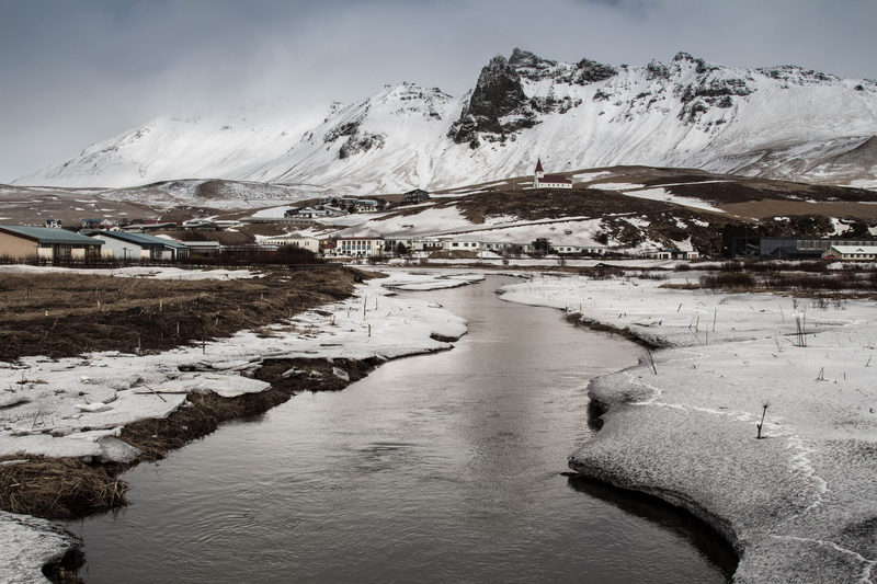 A river through the middle of town, running too fast to freeze.