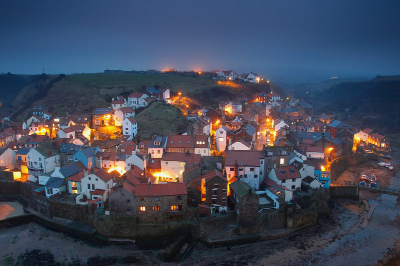 A fishing village at the blue hour, from the hill behind the harbour.